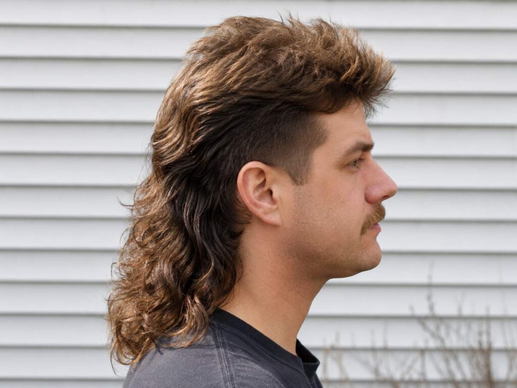 Classic retro mullet hairstyle for men with textured layers and faded sides, stylish modern haircut inspiration